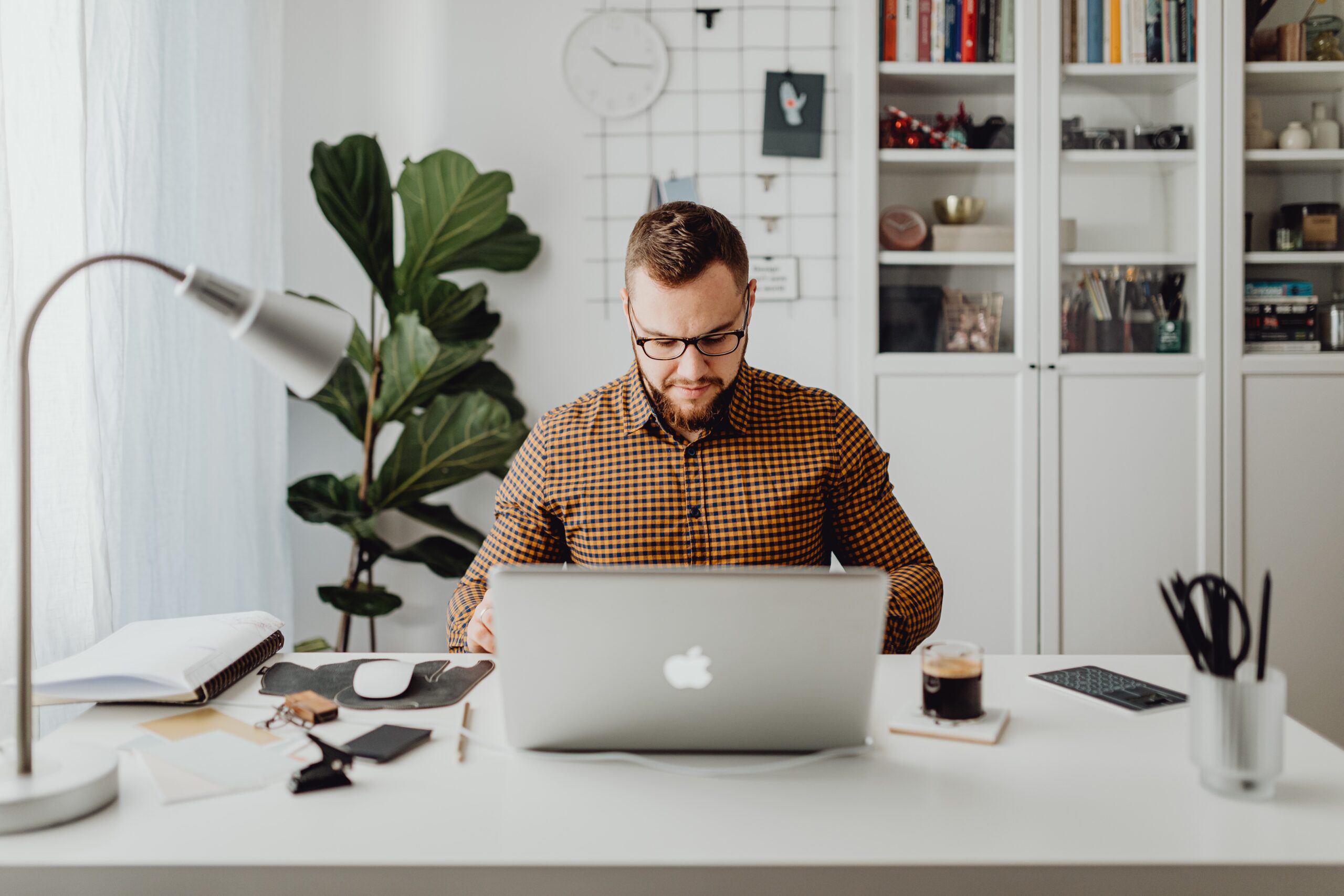 Man sitting at desk with a laptop working